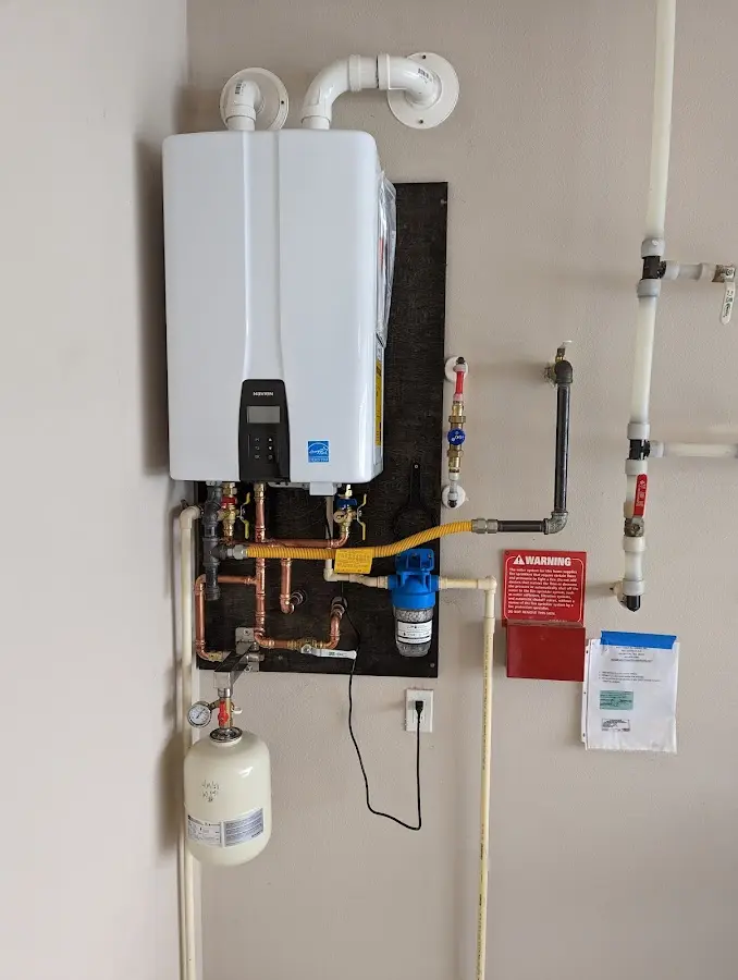 Professional plumber installing copper piping in a Randallstown home